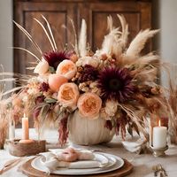 Flowers elevate your Thanksgiving celebration with our "Boho Chic" Thanksgiving Centerpiece." Our Boho Chic Thanksgiving Centerpiece combines the warmth of traditional Thanksgiving elements with a touch of bohemian charm. Dried grasses, carefully selected to capture the earthy spirit of the season, blend seamlessly with fresh, vibrant fresh flowers that symbolize the abundance of the harvest. The interplay of fresh flowers and dried grasses and create a visually striking and naturalized arrangem