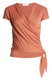 A faux-wrap front flatters on this soft and versatile jersey top cinched with a saucy tie at the hip. 23 1/2" length Surplice V-neck Short sleeves 95% rayon, 5% spandex Machine wash, dry flat Imported Women's Clothing