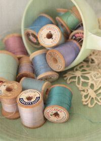 Wooden spools of pastel thread