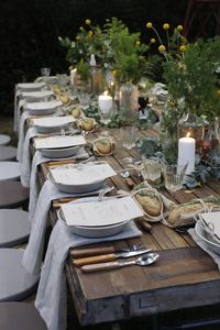 such a beautiful table setting. and i'll take that chunky rustic table too. looks like an old door.