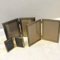 3 Vintage Brass Photo Frame Lot Vintage Wedding Frame Family Glass Frame Holds 6 Photos Elegant Photo Frames All Matching Bronze and brass Most of these are mid century era. Very beautiful and unique lot. This listing includes all 3 frames for the price of the listing. If you need a bigger set I have more brass and brass color frames in stock.  Largest holds 6.5x4.5 inches wide Smallest holds 3 1/4 x 2 1/2 inches wide  Please message me with any questions!  Not all frames are perfect. Only one i