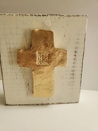 "Crosses make a stunning addition to any home. An elegant way to display your faith, these can be placed on a shelf, lay on a table or stack of books or hang on a wall. Each handmade clay cross is hand painted with real gold leaf and Initial of your choice is added. These would be perfect as gifts. Each piece measures 6\" high x 5 1/2\" wide x 1 1/2\" deep. Each one comes wrapped in a clear gift bag tied with a satin ribbon."