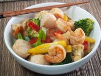 Saucy Seafood Stir-Fry - Shrimp and scallops are stir fried with broccoli, cauliflower, carrots, bell peppers and a secret sauce.