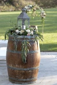 rustic wedding decor outdoor ceremony with wine barrel flowers and greenery arch  #wedding #weddingideas #rusticwedding