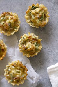 French Onion Tartlets Recipe -- Deliciously savory French onion tartlets made with flaky, crispy mini fillo shells and a creamy caramelized onion filling. The perfect appetizer for Thanksgiving or a holiday party! www.girlversusdough.com @girlversusdough #girlversusdough #partyfood #holidayappetizer