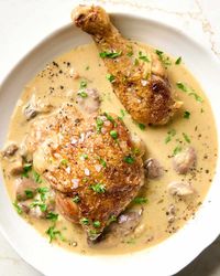 A close up of chicken fricassee in a white bowl