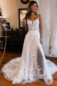 This dress features a luxurious white lace construction with spaghetti straps and a stunning A-line silhouette. It has an elegant sleeveless design and a front slit for added sophistication. Perfect for the sophisticated bride, this dress is sure to make an impression.