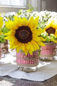 Mason Jar Centerpieces: Sunflower filled jars decorated with burlap