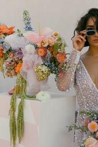 we love how hannah willis creative styled our white column for her styled shoot with daylilies! retro checkered vinyl, colorful florals, wedding decor inspo, modern bride, 2023 wedding trends, funky wedding decor, pinterest wedding ideas, dallas wedding photographer, coral lane rentals, CL x EMERSON