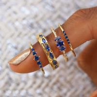 DESCRIPTION One of the most beloved Audry Rose Signature pieces is re-released! Five prong-set Sapphires sparkle brilliantly in this dainty piece of vibrant perfection. DETAILS - (1)2.5mm, (2)2mm, (2)1.5mm Natural Sapphires - Band Width: 1.2mm - 14k Yellow Gold - All Stones are Ethically Sourced - Natural stones may slightly vary in color