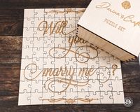 "Will You Marry Me? wood jigsaw puzzle set. Perfect proposal idea for puzzle enthusiasts! Make your engagement unforgettable by assembling this puzzle and revealing your proposal! Every piece has a unique shape. Engraved and cut from high-quality Baltic Birch plywood. Comes in a beautiful wood puzzle box. ENGRAVING options: ☛ CENTRAL engraving - only ONE central piece will be engraved with the \"Will you marry me?\" phrase. The rest pieces will remain blank. ☛ FULL engraving - \"Will you marry m