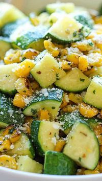 PARMESAN ZUCCHINI AND CORN = 2 T olive oil 2 cloves garlic 4 zucchinis, diced 1 cup corn kernels, frozen, canned or roasted 1/4 t dried basil 1/4 t dried oregano 1/4 t dried thyme Kosher salt and freshly ground black pepper Juice of 1 lime 2 T chopped fresh cilantro leaves 2 T grated Parmesan====