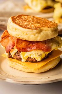 Cooking up a few homemade mcgriddle sandwiches is the best breakfast you can get! These breakfast sandwiches combine the best of both worlds of savory and sweet together with sausage patties, pure maple syrup, omelet, bacon, and cheese sandwiched in between two soft pancakes. It's quick, easy to make, and perfect for meal prep!