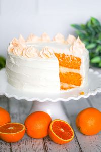 This easy, yummy Orange Creamsicle Cake recipe is totally bursting with a delicious, dreamy combo of orange and vanilla cream flavors! #orange #creamsicle #orangecreamsicle #orangecake #cake #summercake