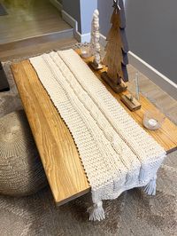 Table runner knitting pattern. Make a knitted table runner in super bulky yarn with a squishy cable. This is a free pattern.