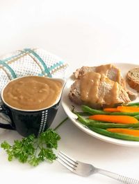 Boneless pork loin in the crockpot is a simple weeknight dinner recipe the whole family will love. Serve savory pork with a homemade gravy made right from the panning drippings. #dinner #onmykidsplate #pork #gravy #howtocook #easyrecipe #cookingtips #sauce #holidayfood