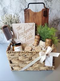 A charming custom wedding gift basket for a beautiful new couple celebrating their special day! Filled with some rustic items for their new home and a cookbook to inspire couples to cook as a team! #weddinggiftideas #weddinggiftideas #weddinggiftbasket #weddinggiftbasketideas #giftsforcouples