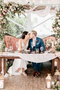 We are crazy in love with this chic riverside wedding in a historic estate. Festooned with cream and burgundy wedding colors, everything from the decorative lanterns spilling out with blooms to the plush velvet sofas will have you begging for a seat at this table. We cannot begin to get over this floral arch backdrop anytime soon, and there is more goodness where this came from on #ruffledblog!