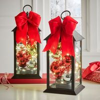 Adorn your tree or mantel with these adorable lantern ornaments featuring warm LED lights. Includes bow.