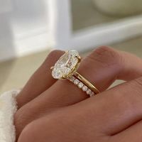 3 CT Oval Cut Moissanite Engagement Ring Set, Bridal Ring Set, Hidden Halo Ring, 14K Yellow Gold Ring Set, Wedding Ring Set women, Ring Set The stones in the jewelry are 100% hand-crafted it is cut and polished by our experienced craftsman. Moissanite is a diamond's best alternative. 𝐍𝐨𝐭𝐞 𝐅𝐨𝐫 𝐁𝐮𝐲𝐞𝐫 : 𝐈𝐧 𝐨𝐮𝐫 𝐀𝐥𝐥 𝐆𝐨𝐥𝐝 𝐉𝐞𝐰𝐞𝐥𝐫𝐲 𝐘𝐨𝐮 𝐖𝐢𝐥𝐥 𝐠𝐚𝐭𝐞 𝐅𝐫𝐞𝐞 𝐞𝐱𝐩𝐫𝐞𝐬𝐬 𝐒𝐡𝐢𝐩𝐩𝐢𝐧𝐠 𝐅𝐫𝐞𝐞 Center Stone Details: → Shape: oval Cut Moissanite →Weight: 3 Ct →Size : 12 x 8 MM → Color: Colorless → Clarity: VVS → Luster: Excellent → Make: High Quality Side Stone Details: → Shape: Round Cut Moissanite →Weight:1 Ct → Color: Colorless → Clarity: VVS → Luster: Excellent → Make: High Quality ● 𝐁𝐚𝐧𝐝 𝐃𝐞𝐭𝐚𝐢𝐥𝐬 * Bandwidth: .1.6 MM (± 0.10) [Customization P