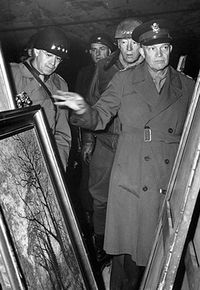 Generals Omar Bradley (left), George S. Patton, and Dwight D. Eisenhower (right) look over art discovered in Merkers salt mines in central Germany on April 12, 1945.