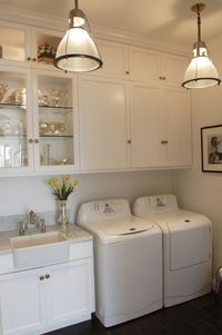 I like how they put the smaller cabinets on top and the regular cabinets right up underneath to create ceiling length upper cabinets- I'd love to do that to a kitchen one day 25 dreamy laundry rooms