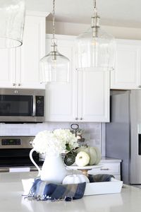 Home- Kitchen island pendant lights, hallway pendant lights, lanterns, changing light fixtures, kitchen lighting, hallway lighting, design mistakes, glass pendant lights, white kitchen, clear glass lighting