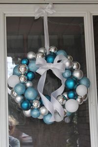 Easiest DIY Christmas Wreath Ever--you only need some Christmas balls, a wire coat hanger and some ribbon! //Beautiful Life Made Easy