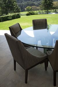 Outdoor Dining | Beige and grey upholstered chairs, glass table, open space, garden view, natural stone floor | Mexico City #HuacalEstudio #InteriorDesign #Mexico #OutdoorDining #MadeInMexico #Styling