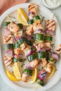 These salmon kabobs are marinated in a tangy mustard sauce and grilled with zucchini and onions. Perfect over a flame for summer grilling! | Salmon Kabobs | Salmon Veggie Kabobs | Salmon Skewers | Summer Salmon Recipes |