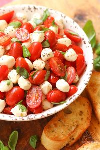 Garden fresh tomatoes and herbs tossed with mozzarella in a two-ingredient dressing might just be the most simple, most delicious salad ever!