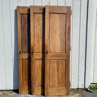 Stunning pair of paneled walnut antique French doors - three pair available - with the original keys and locks - the keys in the shape of numbers 1, 2 and 3! Taken from a French chateau, these beautiful lightly distressed French Provincial paneled doors have a lovely patina.  Would make fabulous interior doors for a bedroom or master bath.  #6133  W together 53” x W each 27.25”