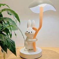 Illuminate your space with this adorable Cute Rabbit Table Lamp. The lamp features a charming rabbit design that adds a playful and whimsical touch to any room. With its soft and gentle glow, it creates a cozy and inviting atmosphere. Whether used as a night light, a decorative piece, or a reading companion, this Cute Rabbit Table Lamp is sure to bring joy and warmth to your home decor.   Product ID: JW5327   Material: Iron, resin, acrylic   Size: 15.7×9.0 inch (40x23 cm)   Powered by: USB Charg