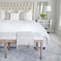 Bedroom inspo,  tufted linen bed, mirrored nightstand, white bedding, tufted linen bench, gray Safavieh rug, Benjamin Moore classic gray paint in walls, chantilly lace paint on trim , target gray blanket, white tulips, white Pom Pom pillow and duvet,   (@thedecordiet) on Instagram: