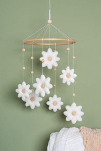 "Daisy nursery mobile will assist you to discover floral nursery decor that will transform your kids room into a flower meadow.  Nursery decoration in daisy theme is beautiful chance to create the design in neutral calm colors. Floral kids room is a beautiful place for your baby. SIZE * height from the wooden hoop to the mobile bottom 13\" (33 cm) * toy`s size 4-5\" (1.5-2 in) This wooden mobile comes with: * 7 daisy flowers All my craft works are made of natural and safe materials in pet-free a