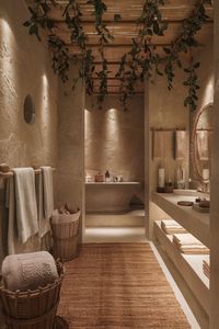 Elevate your bathroom design with textured stone walls, warm lighting, and rattan accents. Create a natural, relaxing space with greenery and soft woven rugs. #NaturalBathroom #EarthyBathroomDesign #BathroomInspiration #CozyBathroomDecor #WovenAccents #GreenBathroomIdeas #RusticStyle #WarmBathroomDesign #StoneWalls #BathroomRetreat