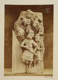 Pakistan (In the collection of Lahore Museum, photographed) Descriptive line Photograph depicting a fragment of a group of figures, some with masks, Greco Buddhist (Gandhara School). India, ca. 1st to 2nd century A.D.