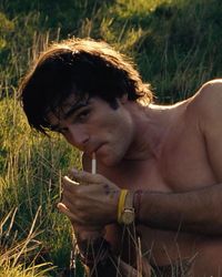 Jacob Elordi smoking a cigarette shirtless