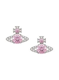 The Vivienne Westwood Ismene Earrings, in polished silver tones, are set with a sparkling pink cubic zirconia in the centre, and smaller white crystals in the Saturn ring to accentuate the design. Metal: Brass. Dimensions: H 1cm x W 2.7cm. Please Note: These earrings are non-refundable. For hygiene reasons, we do not accept returns on earrings. Presented in official Vivienne Westwood packaging. For longer product life, remember to always put this piece on as the 'finishing touch', after using pe