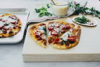 Cherry tomatoes, mozzarella cheese, fresh basil and Victoria® Marinara Sauce make this delicious recipe for Crispy Naan Margherita Flatbread so quick and easy!