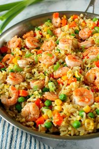 This Shrimp Fried Rice Recipe is the fastest and easiest takeout dinner you can make at home! You only need shrimp, leftover rice, frozen veggies, soy sauce and 15 minutes to turn it into delicious dinner.