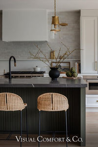 Designed and built by MIF Design, this dreamy neutral kitchen features our timeless Robinson Medium Pendants by Thomas O'Brien above a moody island. Situated on either side of the range hood, our 8" Cabinet Maker's Picture Lights by Chapman & Myers add sleek touches to the heart of the home.