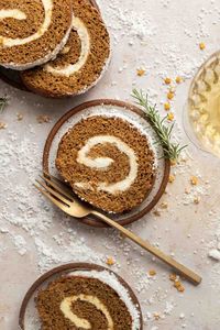 This Gingerbread Swiss Roll cake is both light, fluffy and packed full of ginger flavour. This simple, festive cake, filled with delicious cream cheese filling is perfect for the holiday season. By Emma Duckworth Bakes