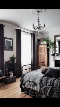 Love the dark bed sheets and curtains. The light wood floors complements them so well. Great natural light in the room.