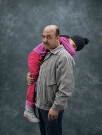 Mohammad Jumma and his 10-year-old daughter Farah, both Syrian refugees living in Berlin, Germany. “This is how I carried my daughter on our journey,” says Jumma, a janitor from Damascus. When this photograph was taken in Berlin, his wife and son were stuck in Greece. Jumma wished for “a simple and normal life. And that this nightmare will end.”