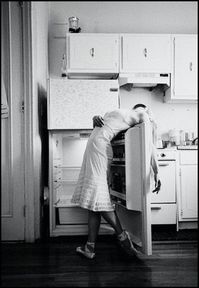 This is unusual to me because not only is she choosing to do this in the kitchen but with the fridge open and it's empty. The clothing she's wearing is also unusual to watch someone doing ballet wears. When I think of ballet I think of leotards and tutu's.