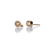 A pair of 14k rose gold set round shaped peach topaz milgrain stud earrings. The peach topaz total 0.44cttw and the diamonds total 0.02cttw. Studs measure approx. 1/4" x 3/16". Handcrafted in Los Angeles, CA, U.S.