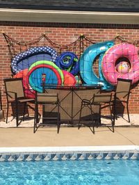 Awesome pool storage ideas - pool toy holder made from cargo net and Command hooks