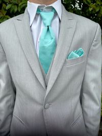 Add a splash of tropical colors in a suit like this. A great beach or destination wedding #destinationwedding #beachweddings #tuxedo #greysuit #seafoam #bridal #groom #menswear