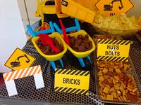 Construction theme party. Kit Kat mini "bricks" in mini wheel barrels. Chex Mix "Nut & Bolts", dump truck dumping potato chips with "Dig in" sign.